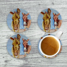 Load image into Gallery viewer, Close-up of a drink coaster showcasing a friendly donkey design, printed on absorbent ceramic for table protection.