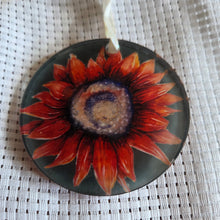Load image into Gallery viewer, Round translucent decorative ornament featuring a bold Red sunflower design on a textured white background.
