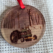Load image into Gallery viewer, Round translucent decorative ornament featuring a boldtractor design on a textured white background.