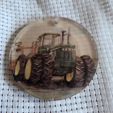 Load image into Gallery viewer, Round translucent decorative ornament featuring a tractor design on a textured white background.
