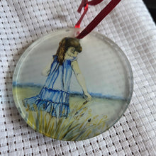 Load image into Gallery viewer, Round translucent decorative ornament featuring a bold girl in Feild design on a textured white background.
