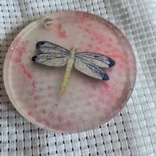 Load image into Gallery viewer, Round translucent decorative ornament featuring a bold dragonfly design on a textured white background.
