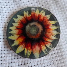 Load image into Gallery viewer, Round translucent decorative ornament featuring a bold sunflower design on a textured white background.
