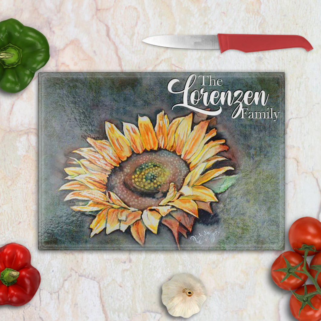 Tempered glass cutting board with a delicate watercolor sunflower in warm yellow and orange tones – elegant farmhouse kitchen accent.
